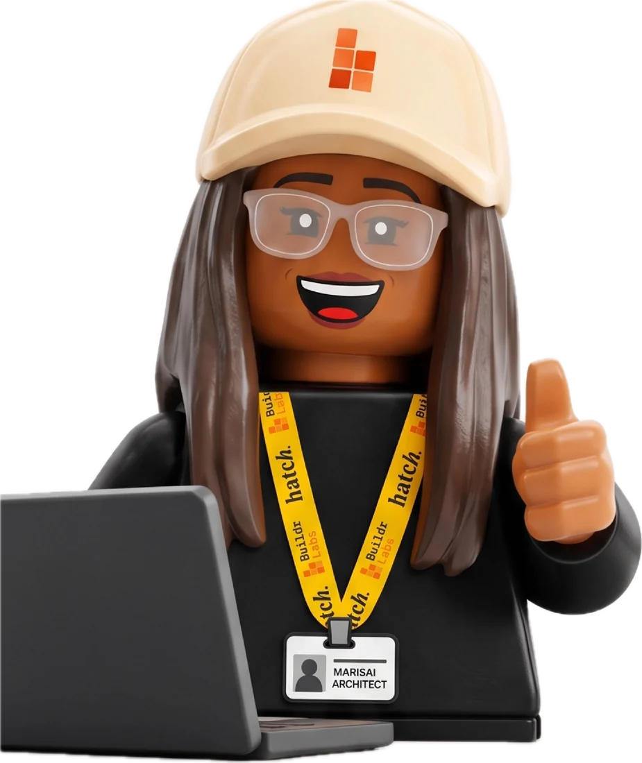 A BuildrLabs Lego builder at a laptop, in a BuildrLabs cap and Hatch lanyard