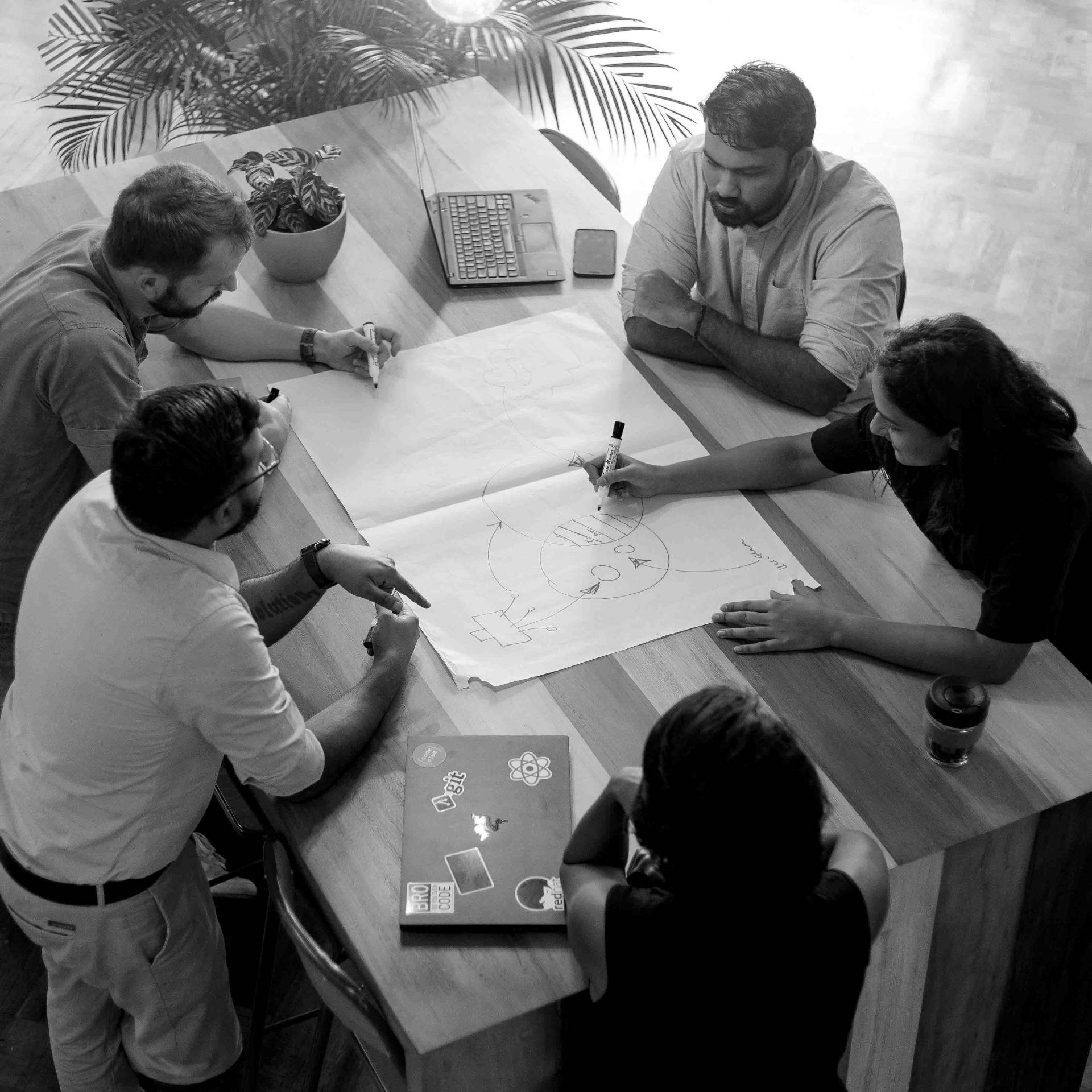 Team collaborating around a whiteboard at Hatch Works