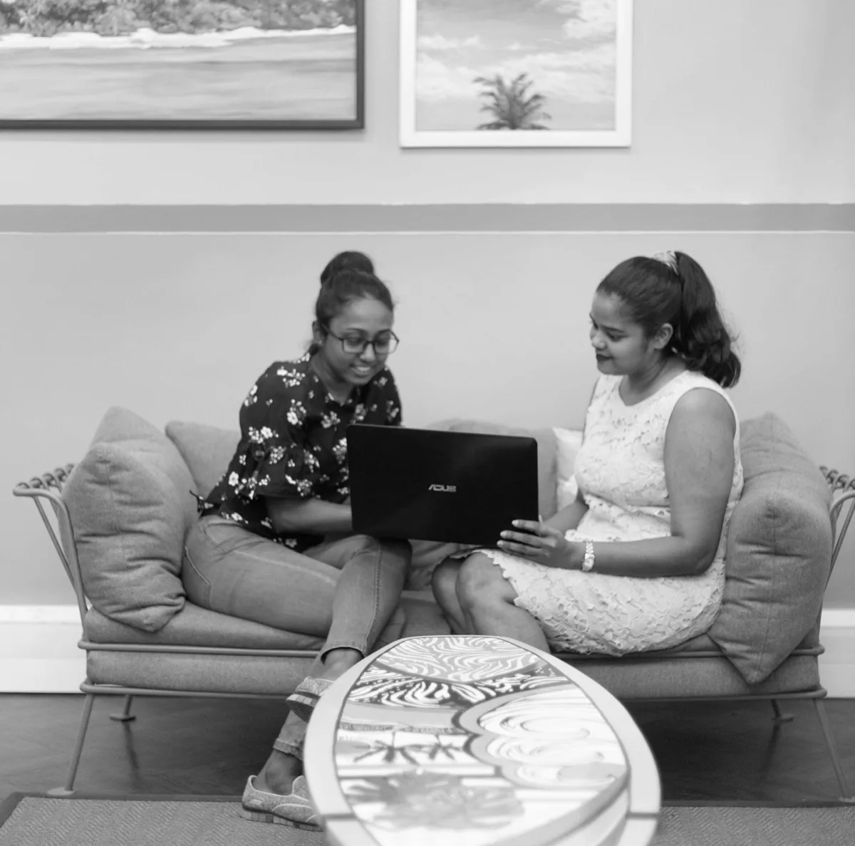 Professionals collaborating over a laptop